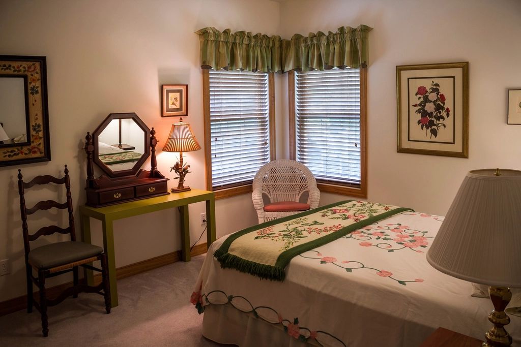 A guest room with two beds and a window
